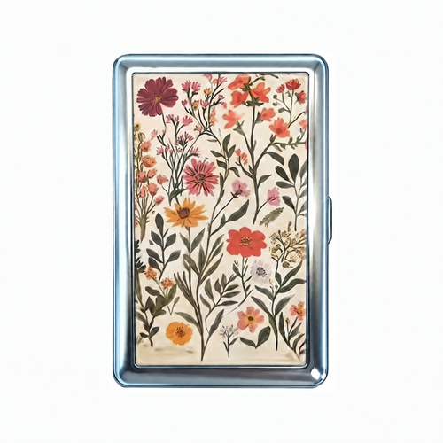 Pressed tin cardholder wallet, closed, printed with wildflowers laid out flat like a pressed flower sheet.