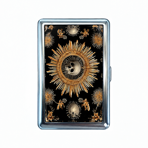Sunstroke tin cardholder wallet, closed, printed with a gilded sunburst with a small skull at its centre.